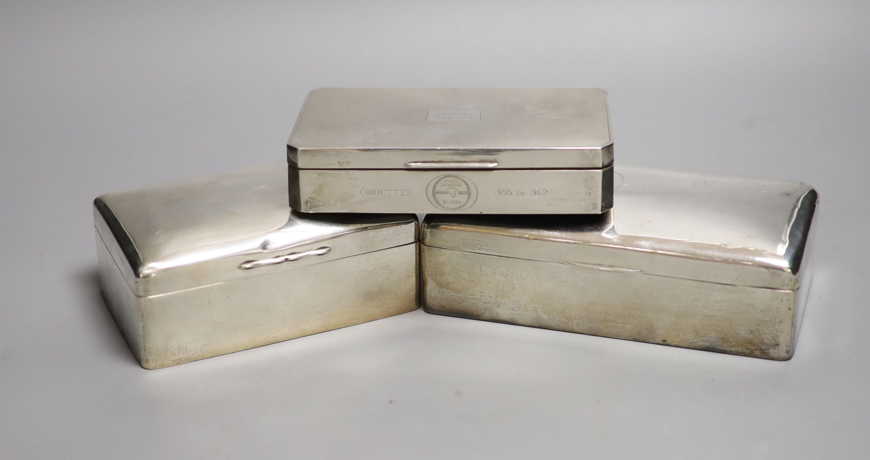 Three silver mounted cigarette cases, largest 17.9cm.